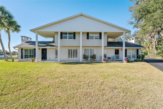 back of property featuring a lawn