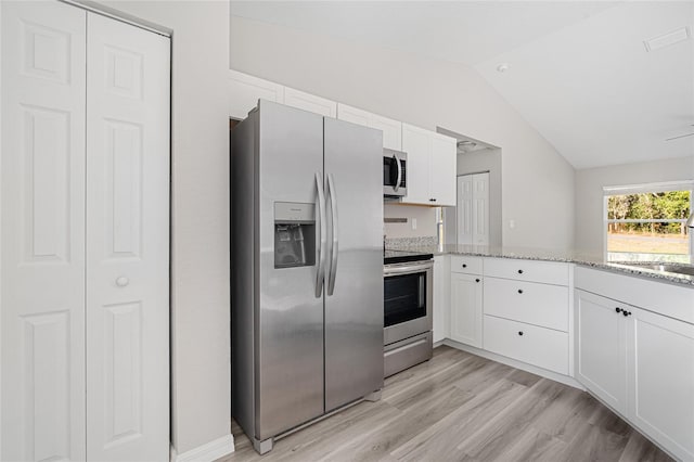 kitchen featuring white cabinets, light stone countertops, sink, and appliances with stainless steel finishes