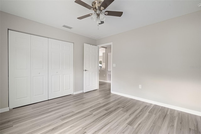 unfurnished bedroom with a closet, ceiling fan, and light hardwood / wood-style floors