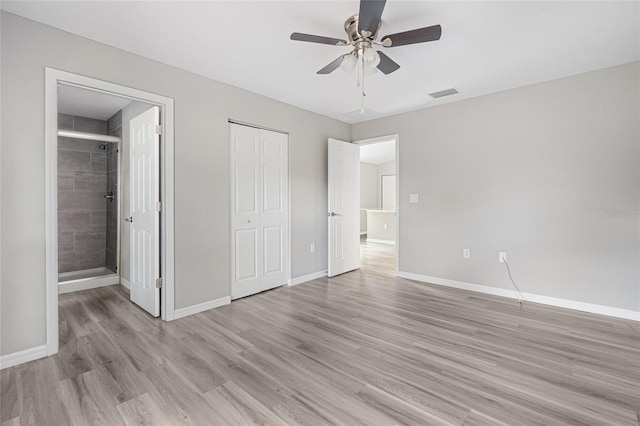 unfurnished bedroom featuring ensuite bath, ceiling fan, and light hardwood / wood-style floors