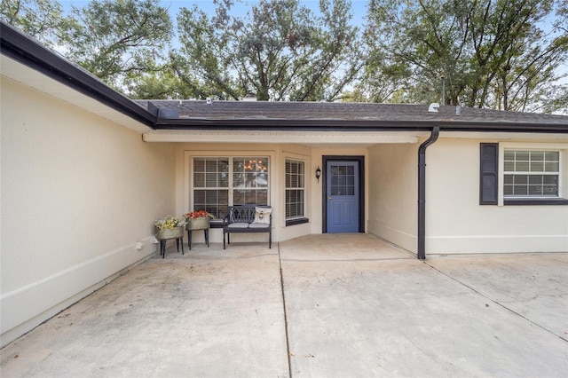 view of exterior entry featuring a patio