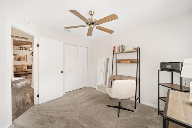 interior space with a closet, ceiling fan, and carpet