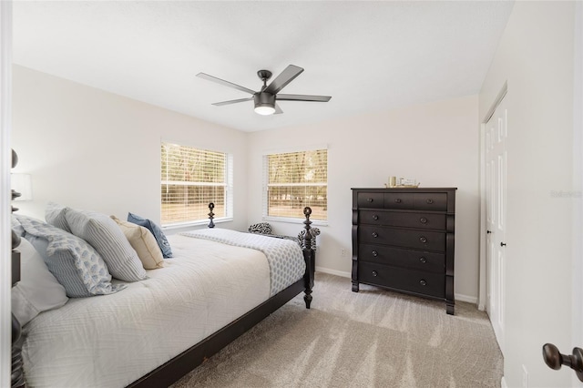 carpeted bedroom with a closet and ceiling fan