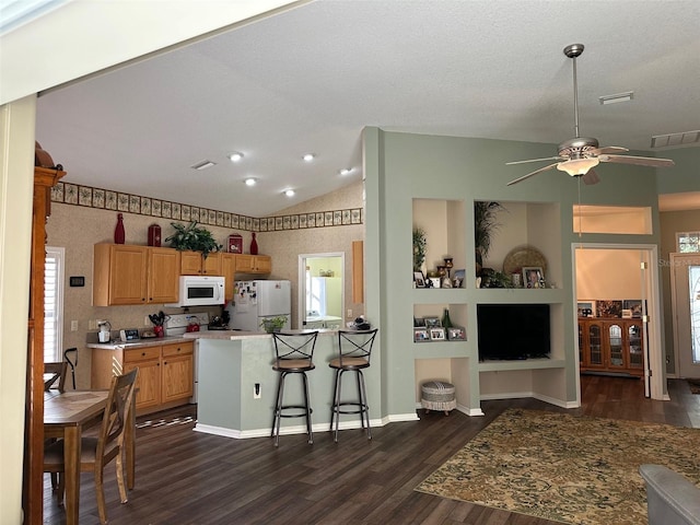 kitchen featuring ceiling fan, built in features, dark hardwood / wood-style flooring, vaulted ceiling, and white appliances