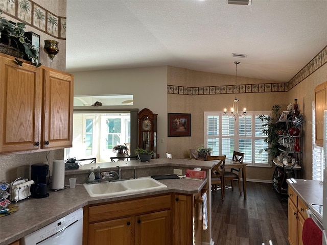 kitchen with sink, dark wood-type flooring, white dishwasher, a chandelier, and vaulted ceiling