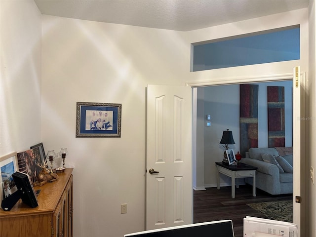 hallway with dark hardwood / wood-style flooring