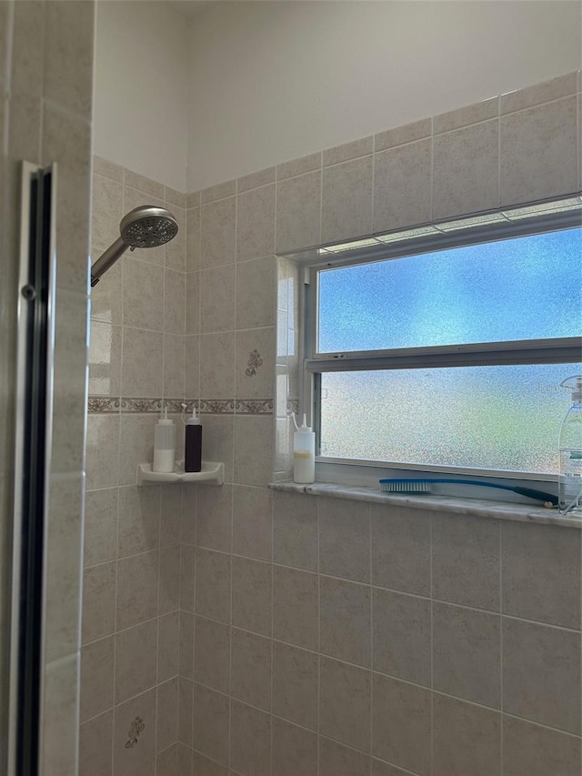 bathroom with a tile shower