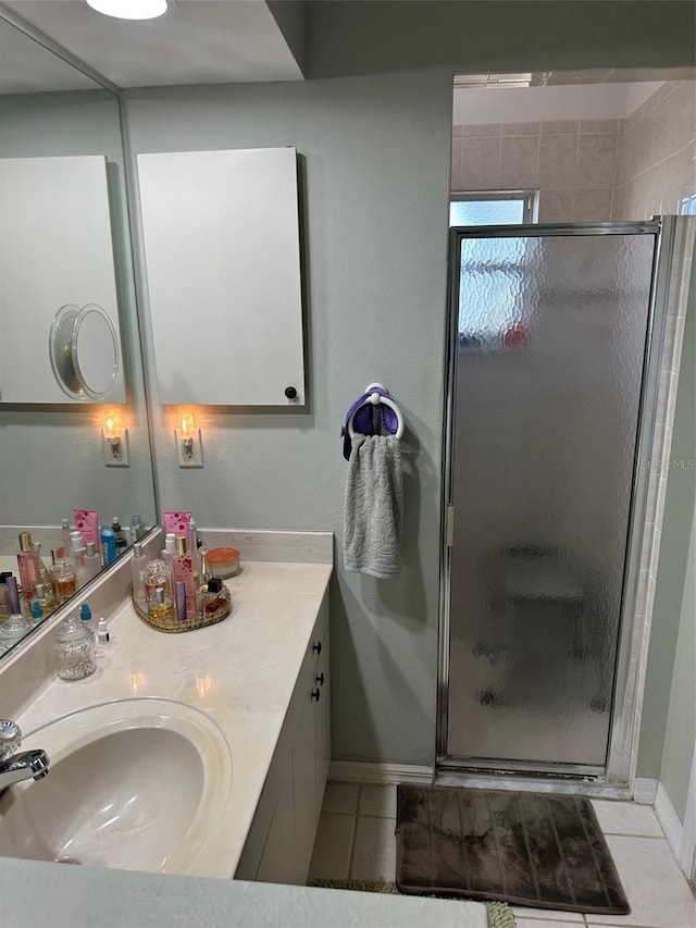 bathroom featuring vanity, tile patterned floors, and a shower with door