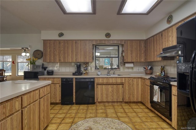 kitchen featuring black appliances, ceiling fan, sink, and tasteful backsplash