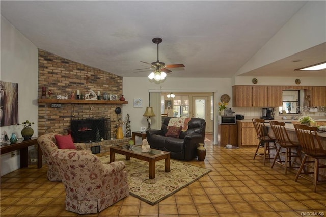 tiled living room featuring ceiling fan, a fireplace, and vaulted ceiling