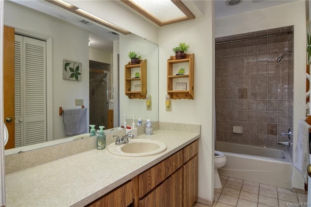 full bathroom with tile patterned flooring, vanity, toilet, and tiled shower / bath