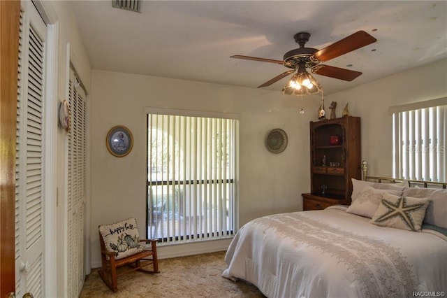 bedroom featuring ceiling fan and light carpet