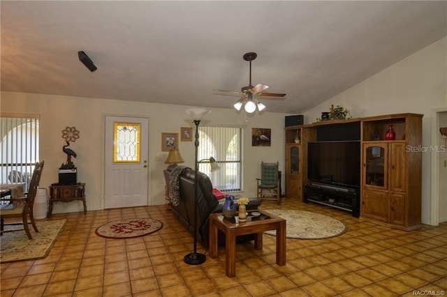 tiled living room featuring ceiling fan and vaulted ceiling