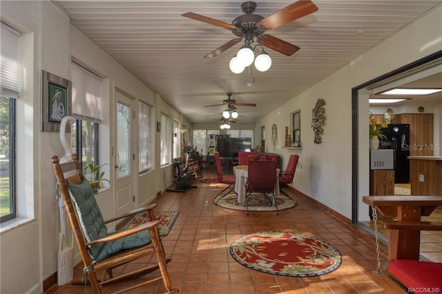 sunroom / solarium featuring ceiling fan