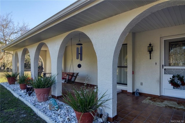 7424 N Nature Trl, Hernando, FL 34442 - view of exterior entry with stucco siding and a porch