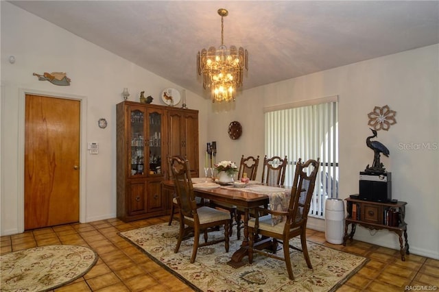 tiled dining room featuring lofted ceiling and a notable chandelier