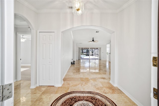 entrance foyer with ceiling fan and crown molding