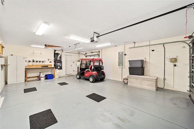 garage with a garage door opener and electric panel