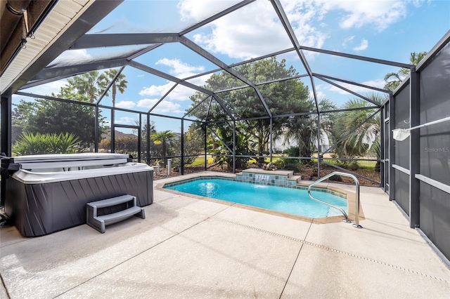 view of pool with pool water feature, a hot tub, a patio area, and glass enclosure