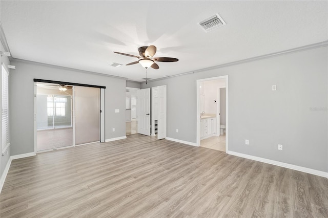 unfurnished bedroom featuring ceiling fan, ensuite bath, crown molding, and light hardwood / wood-style flooring