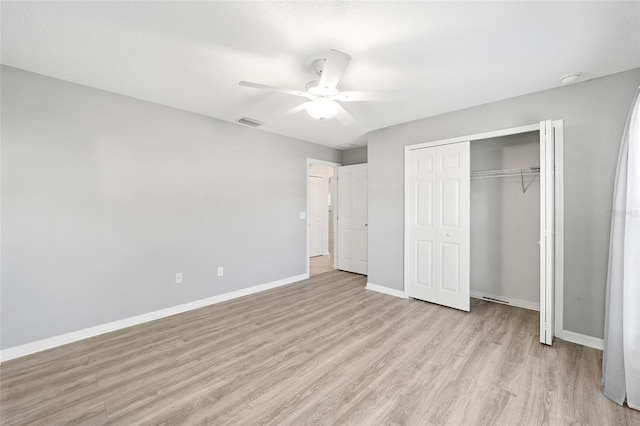 unfurnished bedroom with ceiling fan, a closet, and light hardwood / wood-style flooring