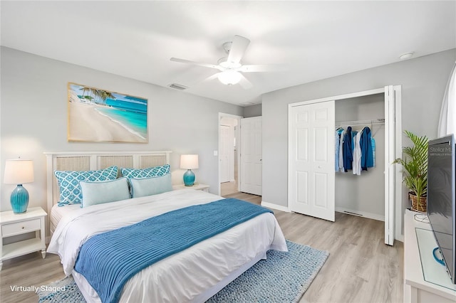 bedroom with ceiling fan, a closet, and light hardwood / wood-style flooring