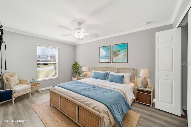 bedroom with dark wood-type flooring, ceiling fan, and crown molding