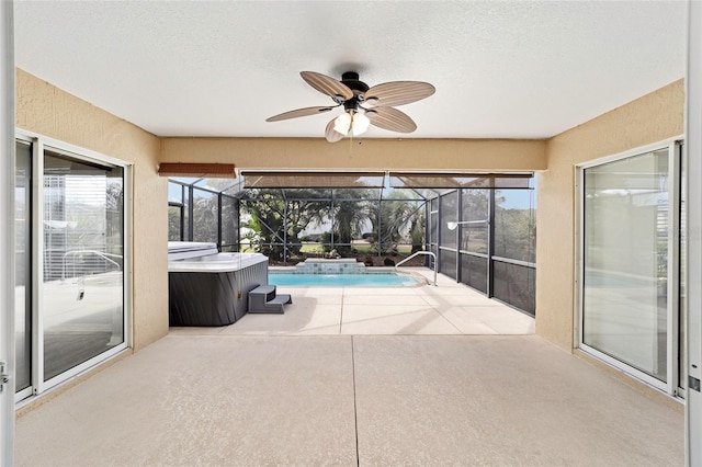 view of pool with a lanai, a hot tub, and a patio