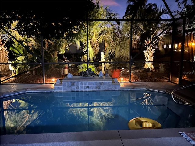 pool at dusk with a lanai