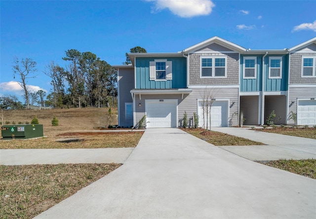 view of front facade featuring an attached garage, board and batten siding, and concrete driveway