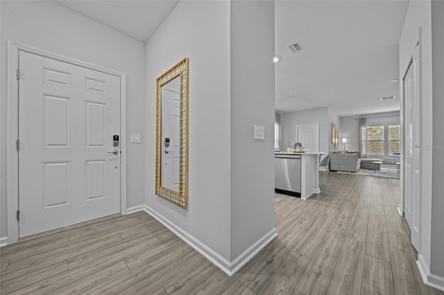 entryway featuring baseboards, visible vents, and light wood-style floors