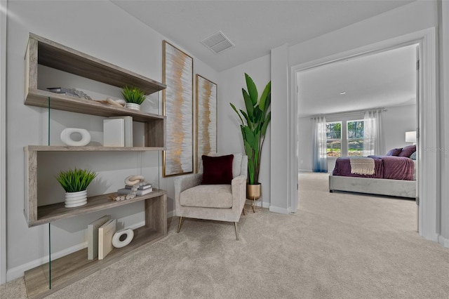 sitting room with carpet, visible vents, and baseboards