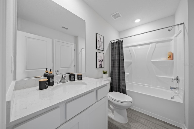 bathroom featuring toilet, shower / bath combo, vanity, and visible vents