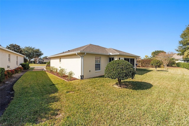 view of side of property with a yard