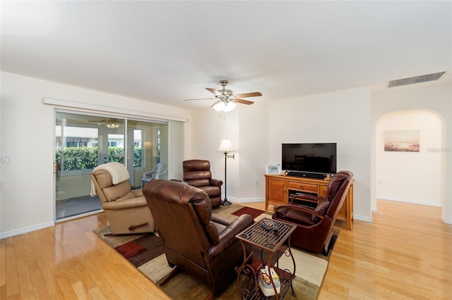 living room featuring ceiling fan, light hardwood / wood-style flooring, and french doors