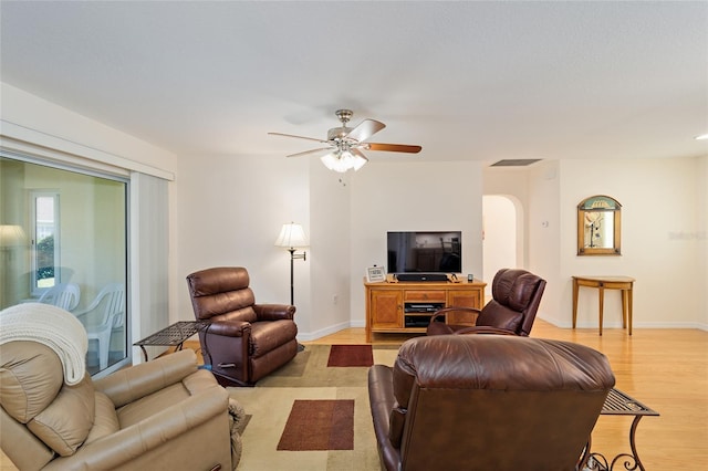 living room featuring ceiling fan and light wood-type flooring