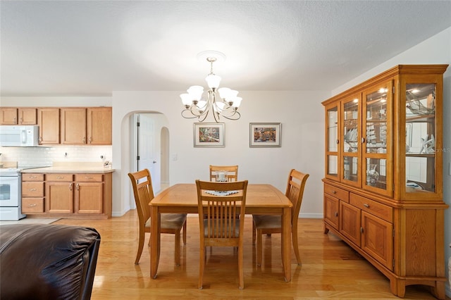 dining room with a chandelier and light hardwood / wood-style floors