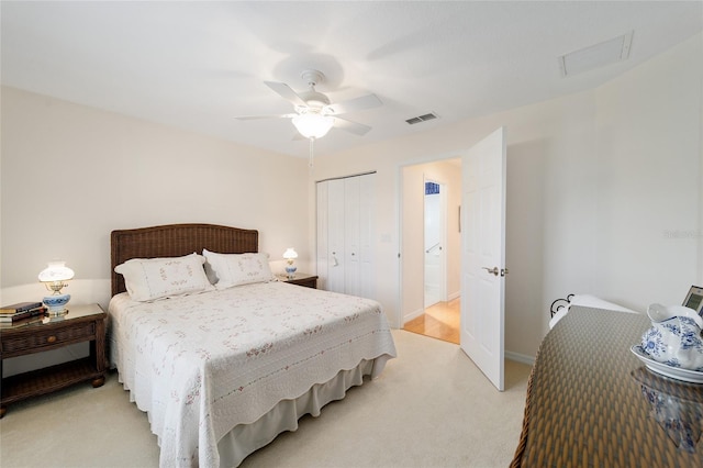 carpeted bedroom with ceiling fan and a closet