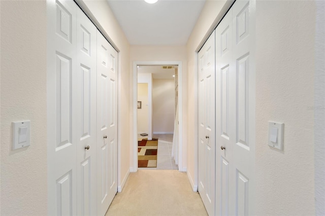 hall featuring light tile patterned floors