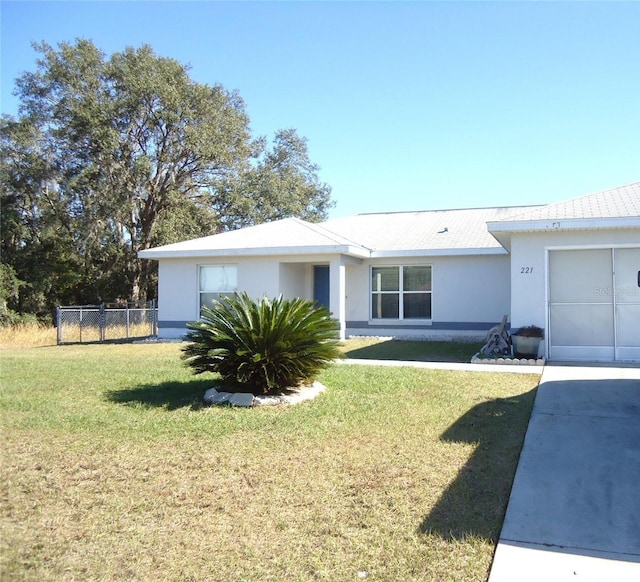 ranch-style house with a garage and a front yard