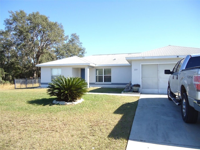 single story home featuring a garage and a front lawn