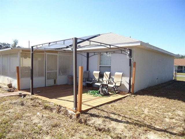 rear view of property with a wooden deck