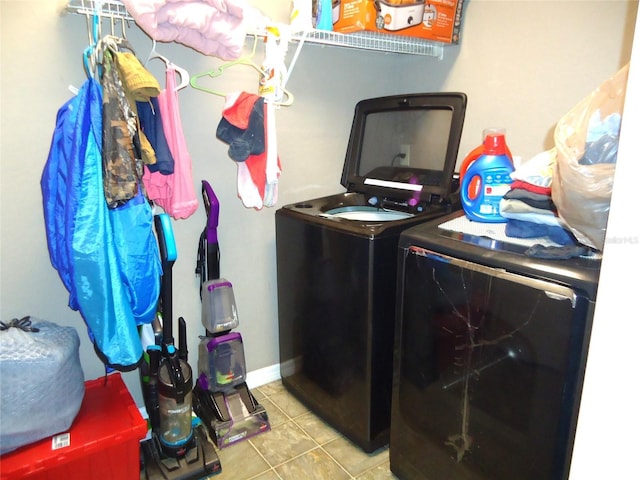 washroom with light tile patterned flooring and washing machine and dryer