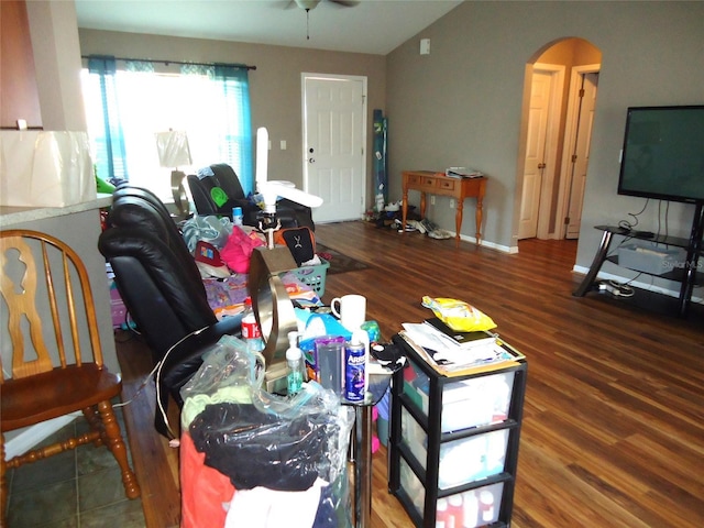 living room with ceiling fan and dark hardwood / wood-style flooring