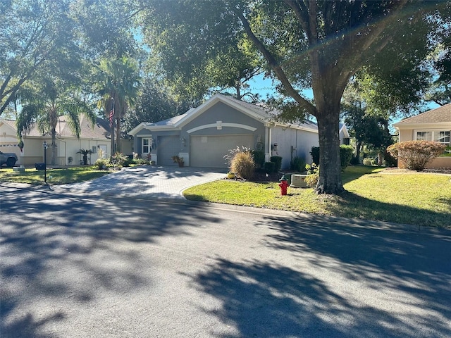 view of front of home with a garage and a front lawn