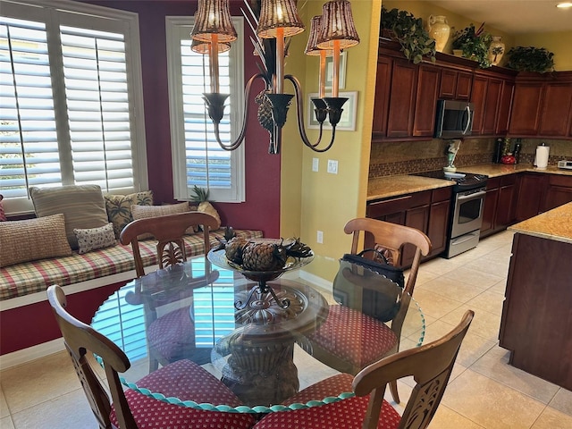 dining room featuring light tile patterned floors and a healthy amount of sunlight