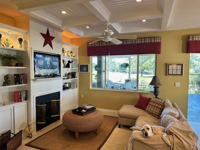 living room featuring ceiling fan, built in shelves, light tile patterned floors, and coffered ceiling