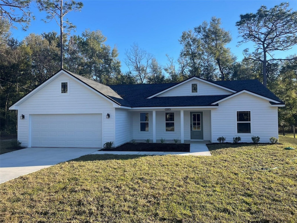 single story home featuring a porch, a garage, and a front lawn