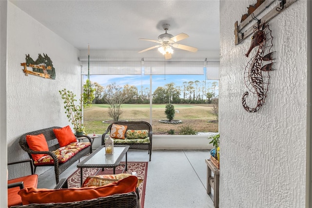 sunroom / solarium featuring ceiling fan