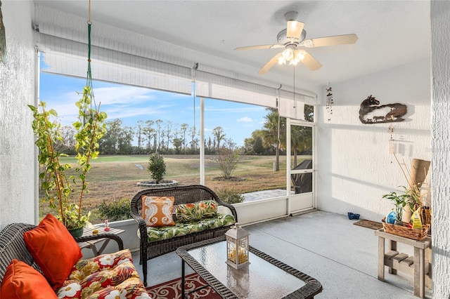 sunroom / solarium featuring ceiling fan